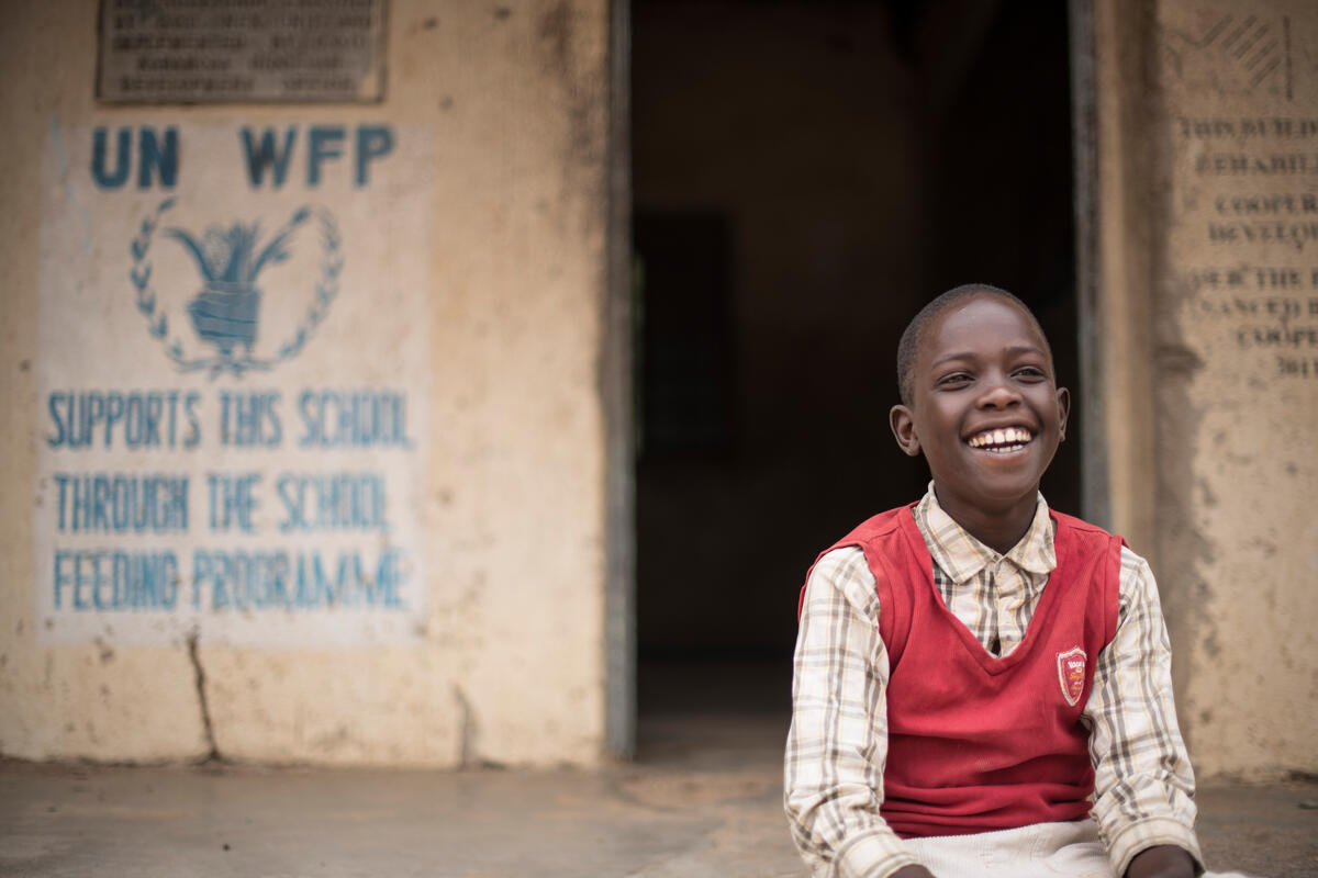 a child from Napumpum Primary School (Karamoja region) waits for his name to be called to collect his take-home rations.